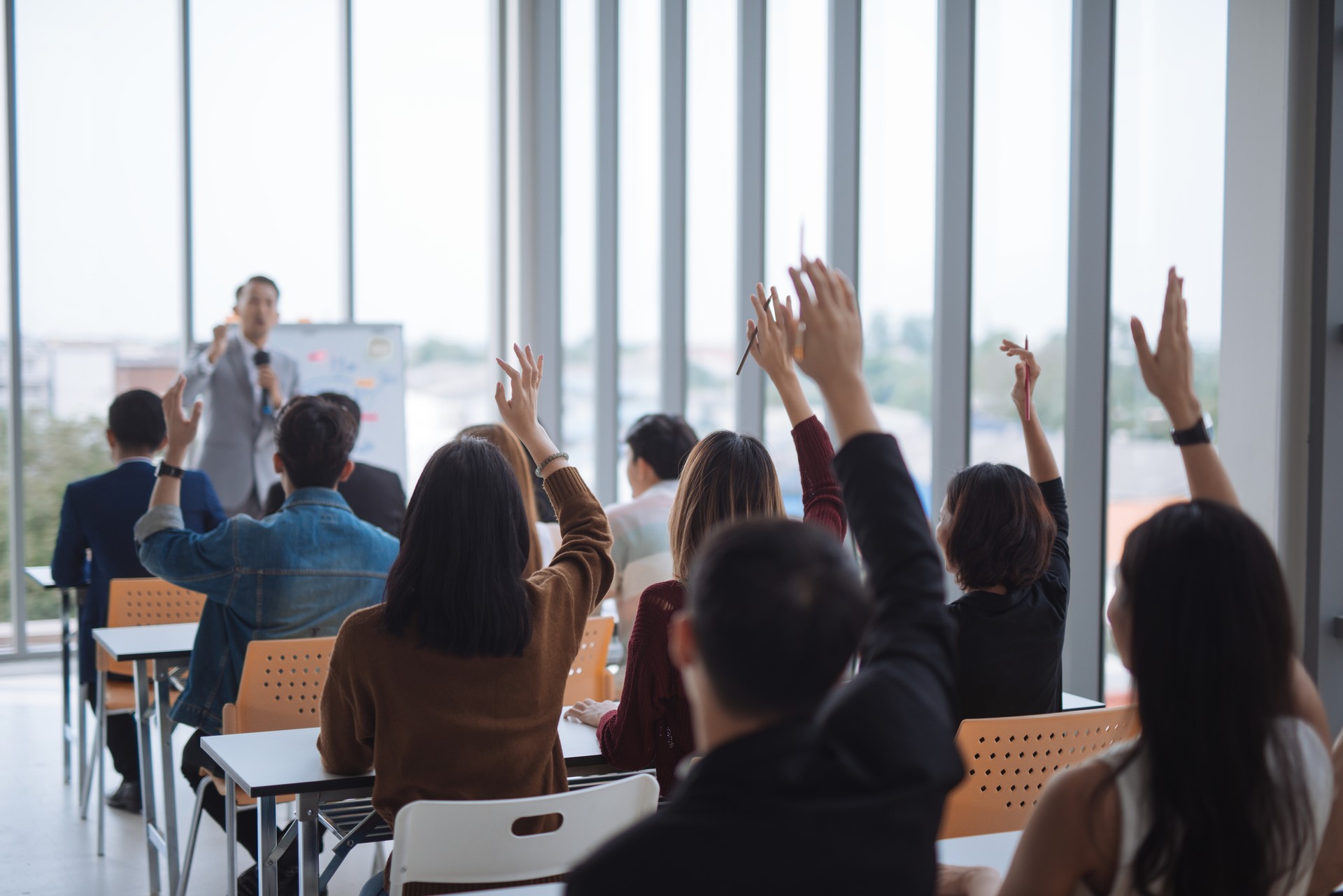 hand raised for Vote and asking at conference seminar meeting room